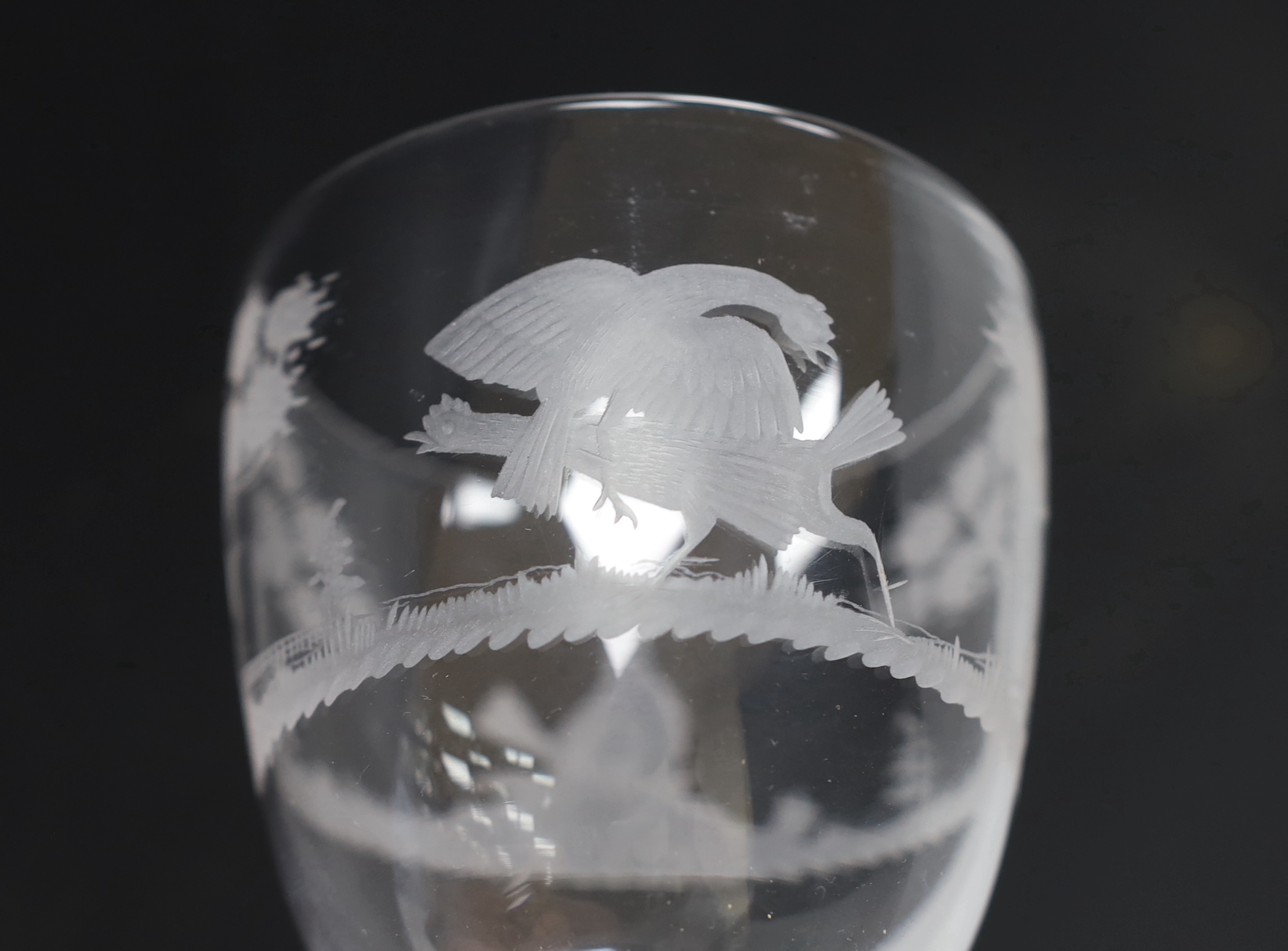 An English lead crystal facet stem goblet, c.1780, round funnel bowl, with hexagonal facet stem, conical foot, engraved in the round with trees and cock fighting scenes, 18.6cm